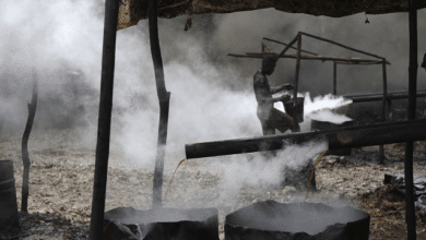 A man works at an illegal oil refinery site