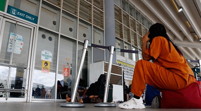 A passenger reacts while stranded at the gate of the Nnamdi Azikiwe International Airport Abuja NigeriaEconomyLabourStrike