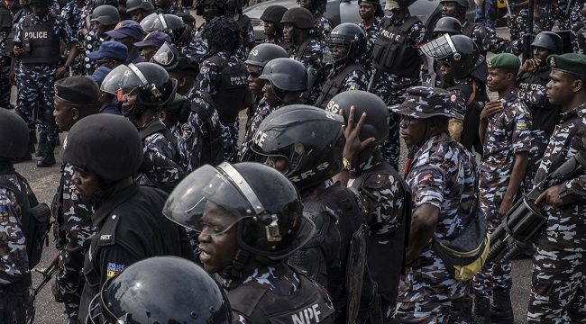 Man nabbed with fresh human skull in Ibadan 1 Police officers stand near the Lagos State Governors office as protesters march during a mourning vigil in Ikeja Lagos NigeriaEconomyPoliticsUnrest