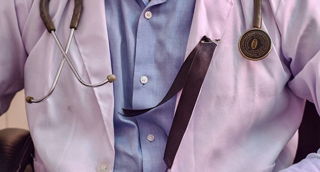 A doctor is pictured wearing a black ribbon IndiaWomenDoctorsStrikeHospital